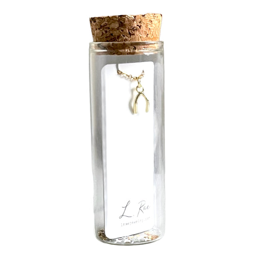 Gold Wishbone Charm Necklace. Glass Vial Display